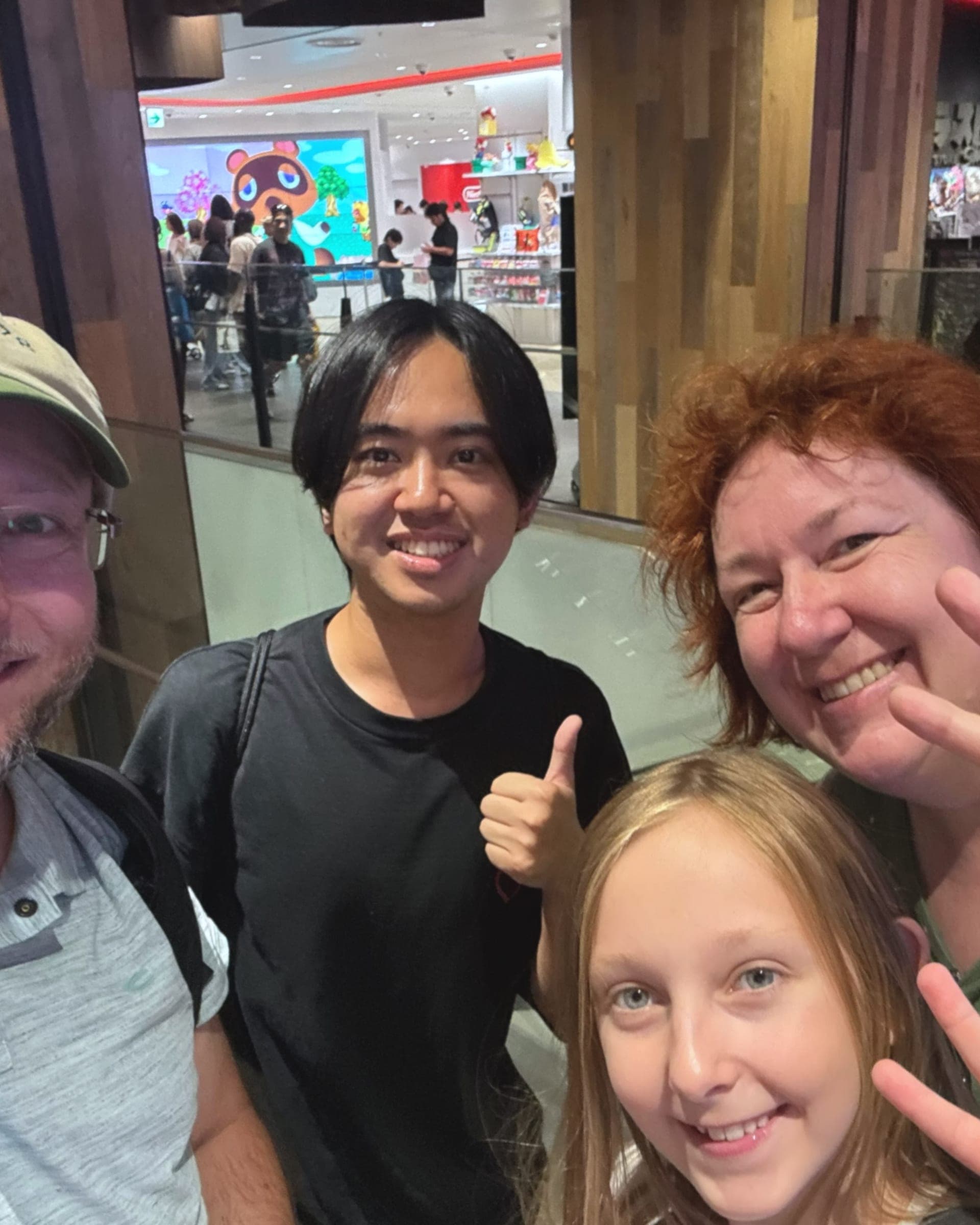a guide with a visiting family of three, thumbs up