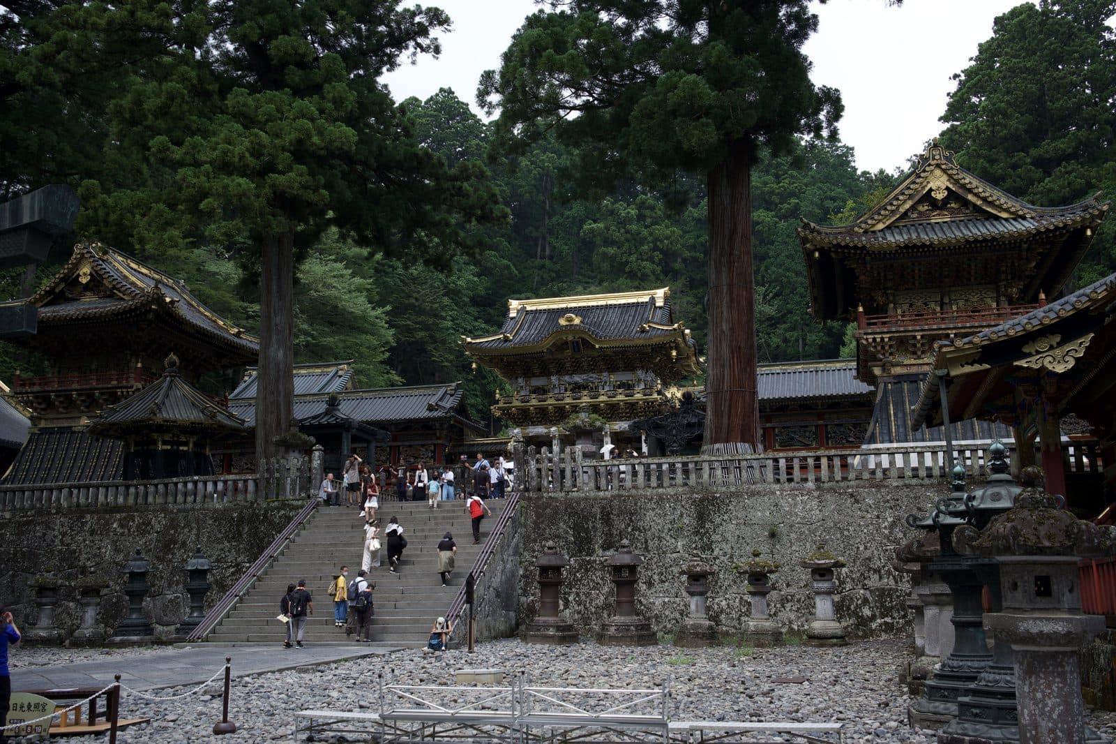 stone steps and lanterns rising through Toshogu's courtyard, gilded gates above