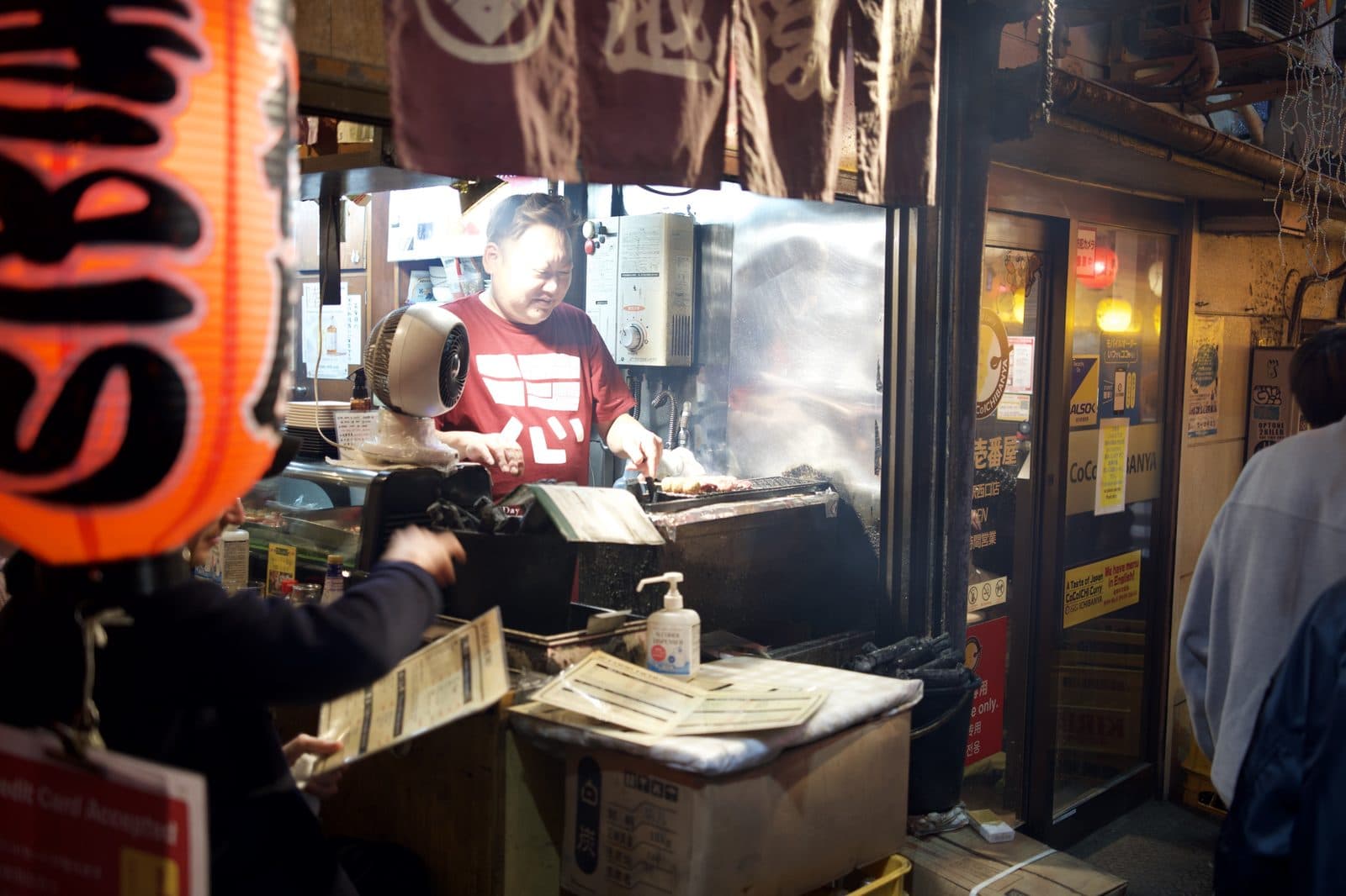a food stall window glowing at night