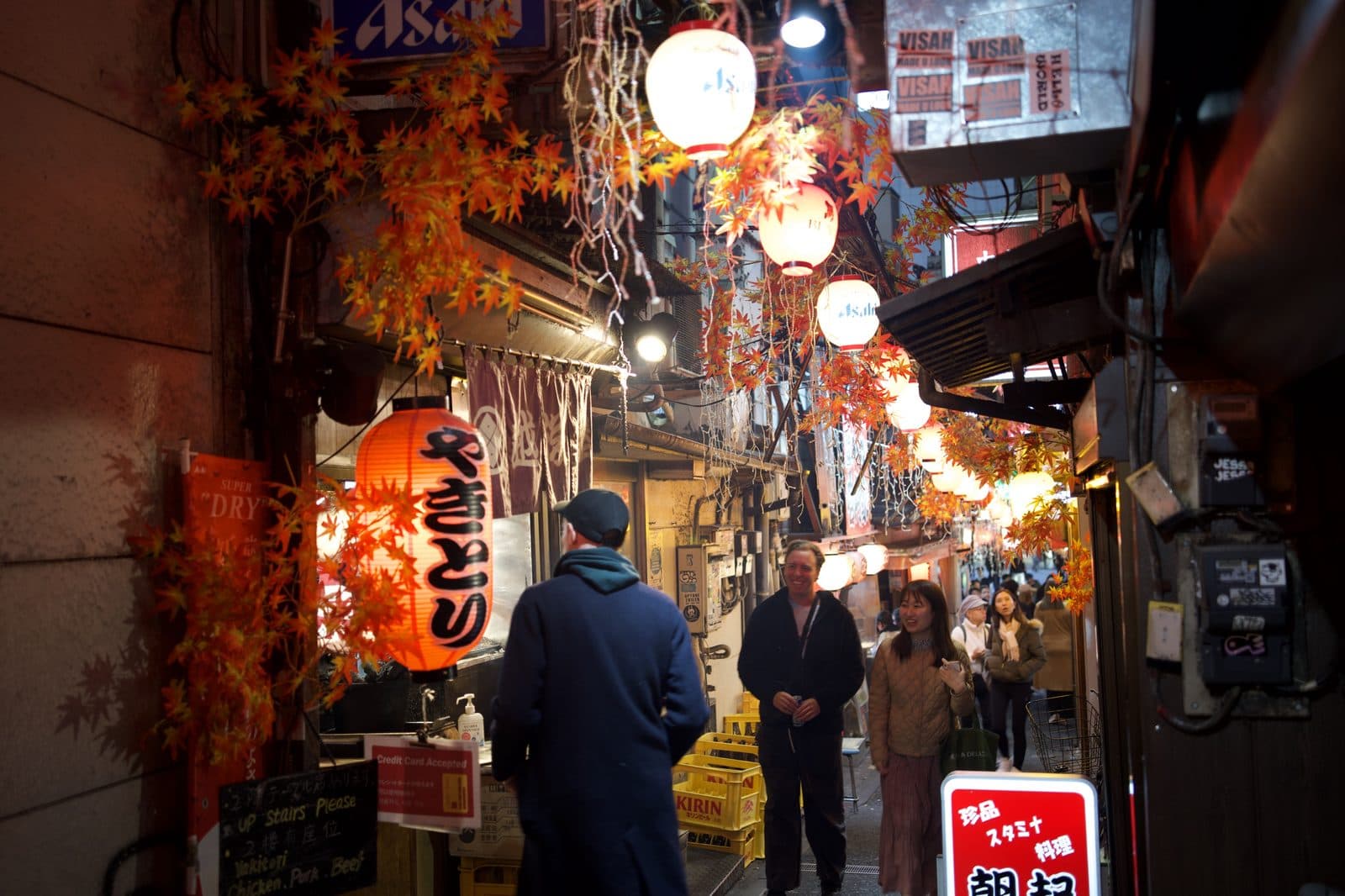 lantern-lit bar fronts in a narrow alley